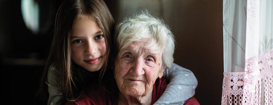 Elderly woman with her little granddaughter.
