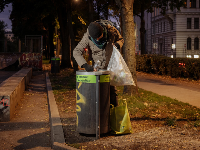 Ein Mann sucht im Müll nach Verwertbarem 