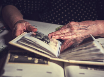 male hands on an old vintage photo album