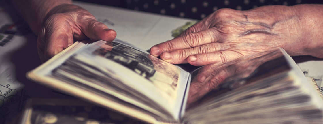 male hands on an old vintage photo album