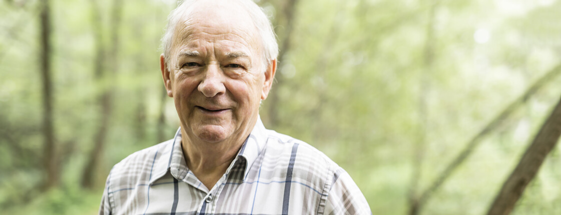 Senior man in the nice forest park