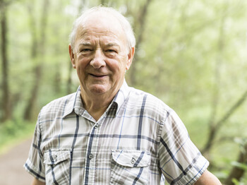 Senior man in the nice forest park